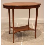 An Edwardian satinwood oval occasional/lamp table, the oval moulded top, upon slender tapering