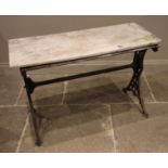 A Victorian cast iron pub table, the twin trestle type supports cast with openwork foliate detail,