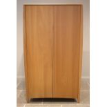 An Ercol Savona light oak two door wardrobe, late 20th/early 21st century, opening to an internal