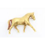 An 18ct yellow horse brooch, the realistically modelled horse striding out with matte detailed body,