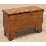 An 18th century elm six plank coffer bach, with a hinged and moulded cover, upon 'V' cut end