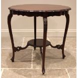 An Edwardian mahogany occasional table, the shaped top with a moulded edge, upon slender leaf