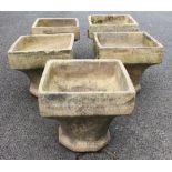 Five stoneware chimney planters, each with an octagonal rim, flared to a square base, 37cm high,