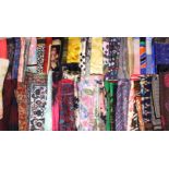 A collection of square silk and synthetic silk scarves, to include extensive, paisley, ditsy floral,