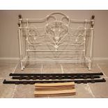 A Victorian style painted iron bed, the head and foot boards of openwork, scroll and roundel form,