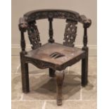 A Victorian carved oak corner chair, the curved top rail extending to lion mask terminals above