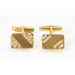 A pair of yellow metal and diamond cufflinks, the rectangular cufflinks set with twelve round cut