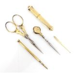 A 19th century French yellow metal travelling sewing kit, comprising needle case, pencil,