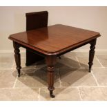 A Victorian mahogany extending dining table, the rectangular top with rounded corners, upon tapering