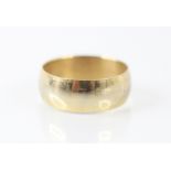 A yellow metal wedding band, the wide band of plain polished form, ring size O, 3gms along with a