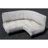 A contemporary corner sofa, 20th century, of curved 'C' form, upon painted vase shaped legs, 68cm
