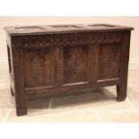 A late 17th/early 18th century oak coffer, the three panel cover on hook and eye hinges opening to a