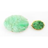 A Birks Ellis ‘jade’ brooch, the carved oval panel with scalloped edge depicting floral detail,