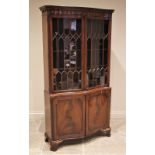 A Chippendale style serpentine mahogany display cabinet, mid 20th century, the moulded Greek key