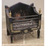 An Adam style cast iron fire basket, the architectural shaped back panel, over a pair of brass urn