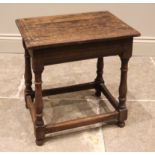 An 18th century oak and elm joint stool, with a moulded and figured elm seat, slender baluster