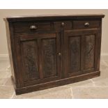 An Edwardian walnut side cupboard, the moulded top with a dentil frieze over three drawers and a