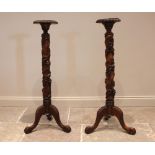 A pair of 19th century style mahogany torchere, late 20th century, each with a circular tray top