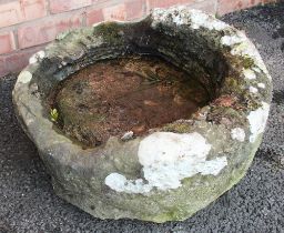 A 19th century sandstone circular trough, with a shallow well, 26cm H x 59cm D (at fault)