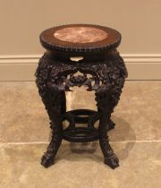 A Chinese carved hardwood and rouge marble jardiniere stand, 19th century, the circular inset marble