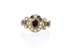 A 19th century split pearl and red stone ring, the red stone centre (possibly foil backed) with