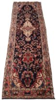 An Iranian wool runner, in red, blue and ivory colorways, the all over foliate design upon a