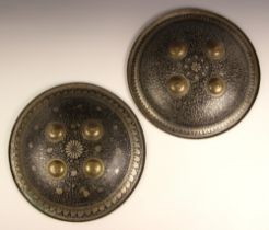 A pair of Indo-Persian circular shields or dhals, 19th century, the convex steel bodies with