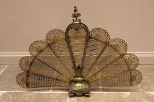 A brass folding peacock spark guard, early 20th century, with an urn finial above nine fretwork