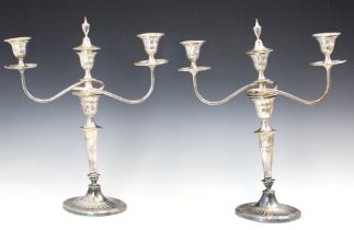 A pair of Edwardian silver candelabra, Hawksworth, Eyre & Co Ltd, Sheffield 1905, the three urn