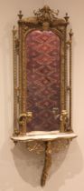 A Victorian giltwood and gesso wall mirror and shelf, the arched frame decorated with fern leaves