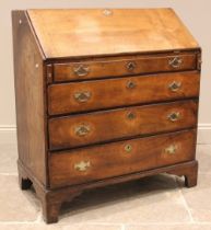 A George III fruitwood bureau, the fall front opening to a compartmented interior with central