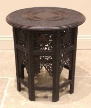 An Anglo Indian folding hardwood table, late 19th/early 20th century, the circular top with carved