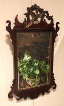 A George III style mahogany fretwork wall mirror, with painted gilt phoenix crest, 80cm x 49cm, late