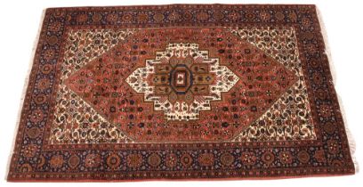 A hand knotted Iranian Bidjar wool rug, in ivory, pink, green and blue colourways, the central
