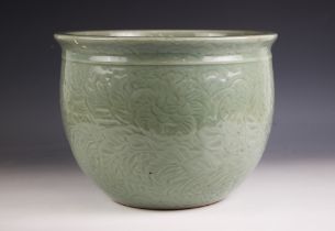 A large Chinese porcelain Longuan celadon jardienere, the circular shaped planted incised with lotus