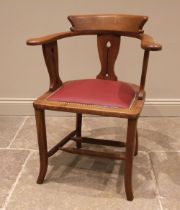 An Arts & Crafts oak desk chair, early 20th century, the horse shoe shaped top rail upon three