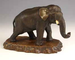 A Japanese bronze model of an elephant, Meiji Period (1868-1912), modelled standing with its trunk