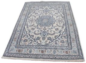 A thick pile wool rug, in blue, ivory and grey colourways, the central foliate medallion upon a