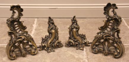 A pair of French rococo brass fire dogs, late 19th century, each of typical cast scroll and