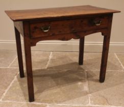 A George III vernacular fruitwood side table, the four plank oversailing top above a single pine