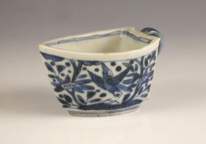 A Chinese porcelain blue and white sauce boat, 18th century, of boat form and decorated birds amidst