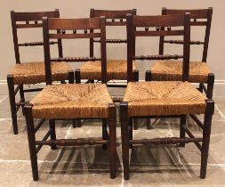 A set of five Regency fruitwood country chairs, each with a bobbin turned rail back over an envelope