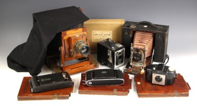 A Thornton Pickard Imperial Triple Extension half plate field camera, folding mahogany and brass