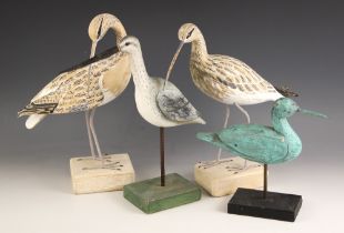 Four folk art style carved and painted wooden wading birds, three naturalistically modelled and