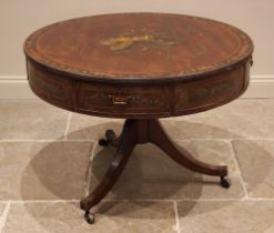 A George III mahogany drum table in the manner of Sheraton, the circular top centred with a