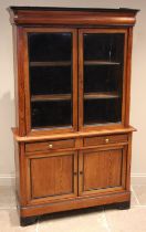 A pitch pine glazed bookcase, late 19th century, the ogee moulded cornice embellished with