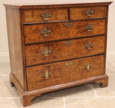 A burr elm chest of drawers, early 18th century, the quarter veneered and cross banded top over an