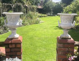 A pair of Victorian cast iron Campana shaped garden urns