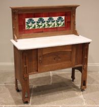 A honey oak tiled back Arts and Crafts washstand, in the manner of Liberty & Co, early 20th century,