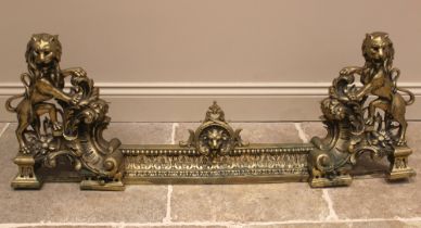 A 19th century gilt brass fender, centred with an interlaced leafy shell enclosing a lion's mask